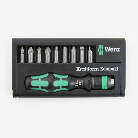 Wera - 5056653001 KK 10 Compact Bitholder and Bit Set, 10-Piece: This image shows a black plastic case containing a set of screwdriver bits and a handle. The handle, which is black with two green stripes, lies horizontally at the bottom of the case, and above it are ten silver-colored screwdriver bits arranged in a row. The brand name "Wera" is visible in white letters on the right side of the case.