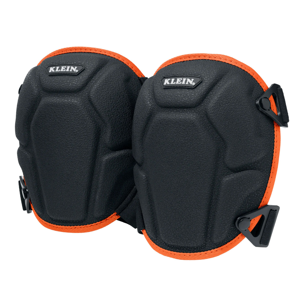 A pair of black Klein knee pads with bright orange trim and black plastic buckle closures, shown against a solid white background.