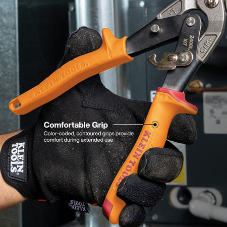 A close-up of a gloved hand holding a pair of Klein Tools pipe wrenches with bright orange and black handles against a dark industrial background. White text on the image reads 'Comfortable Grip' with a subtitle about color-coded, contoured grips providing comfort during extended use.