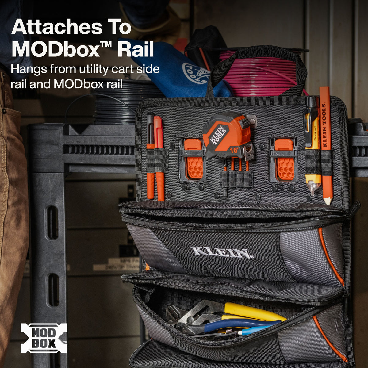 A Klein hanging tool organizer pouch mounted on a utility cart rail, shown with tools inside and text explaining compatibility with the MODbox Rail.
