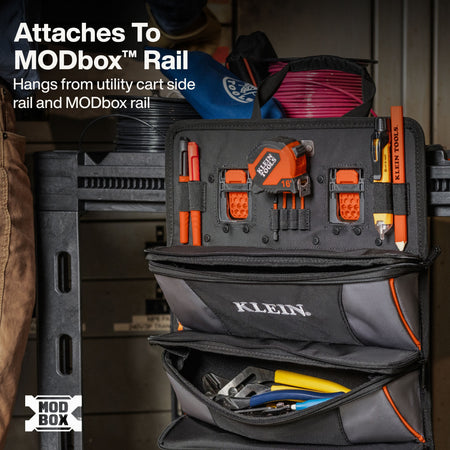 A Klein hanging tool organizer pouch mounted on a utility cart rail, shown with tools inside and text explaining compatibility with the MODbox Rail.