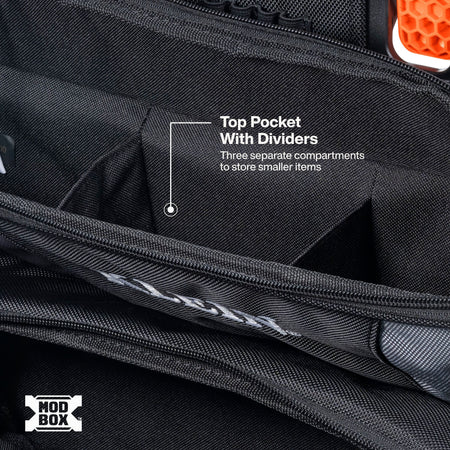 Close-up of a black backpack interior showing a top pocket with divider, white text reading 'Top Pocket With Dividers' and 'Three separate compartments to store smaller items,' plus a MOD BOX logo in the lower left.