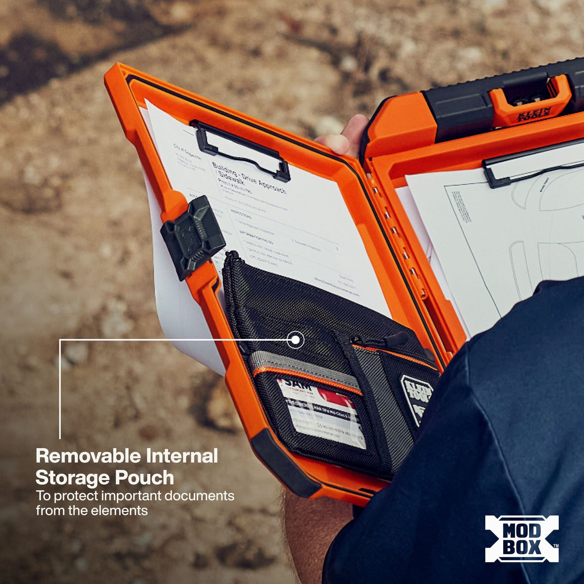 An open orange and black MOD BOX document storage case being held by a person outdoors. The case has built-in document pockets, clips, and a removable internal storage pouch, with text overlay explaining the storage pouch feature.
