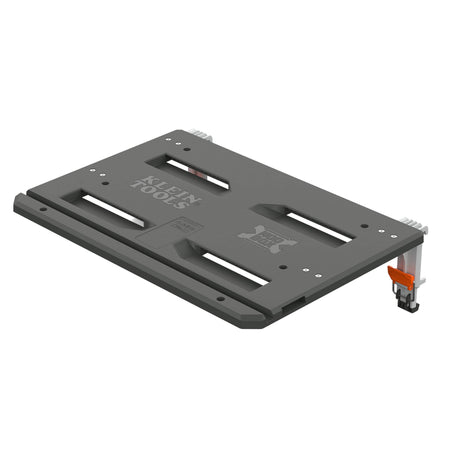 An image displays an isolated product rendering of a dark-gray modular adapter plate or mounting shelf from the Klein Tools MODbox™ modular storage system, angled in a three-quarters perspective against a clean white background.   