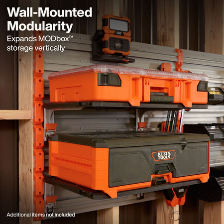 An image shows an installed modular workshop storage setup featuring multiple Klein Tools MODbox™ units mounted vertically to a wall rail panel system.   