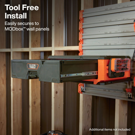 Klein ToolBox 750-8 tool drawer mounted on a wall panel system inside a wood-framed structure, with text reading 'Tool Free Install' and 'Easily secures to MODbox wall panels.'.