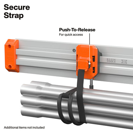 An orange Klein Tools secure strap with a black webbing loop shown securing a bundle of silver metal pipes. The image includes text overlays explaining the 'Secure Strap' and its 'Push-To-Release' feature.