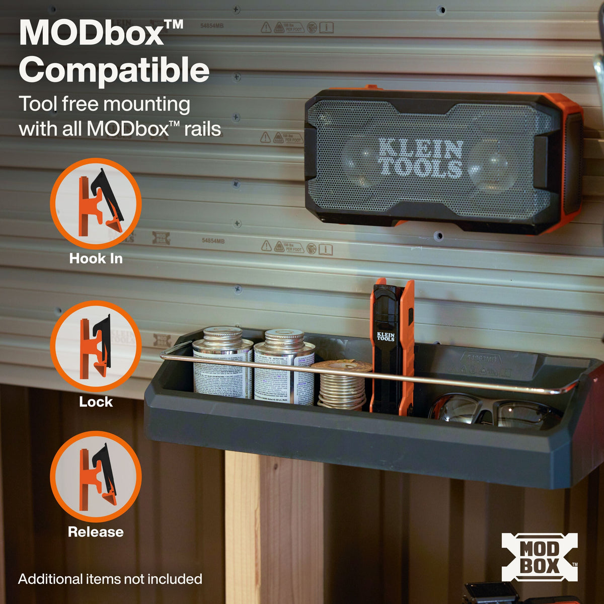 A wall-mounted tool organizer shelf with a small speaker attached to the rail, shown in a garage-like setting with storage bins and tools. Text on the image explains MODbox compatibility and shows hook-in, lock, and release positions.