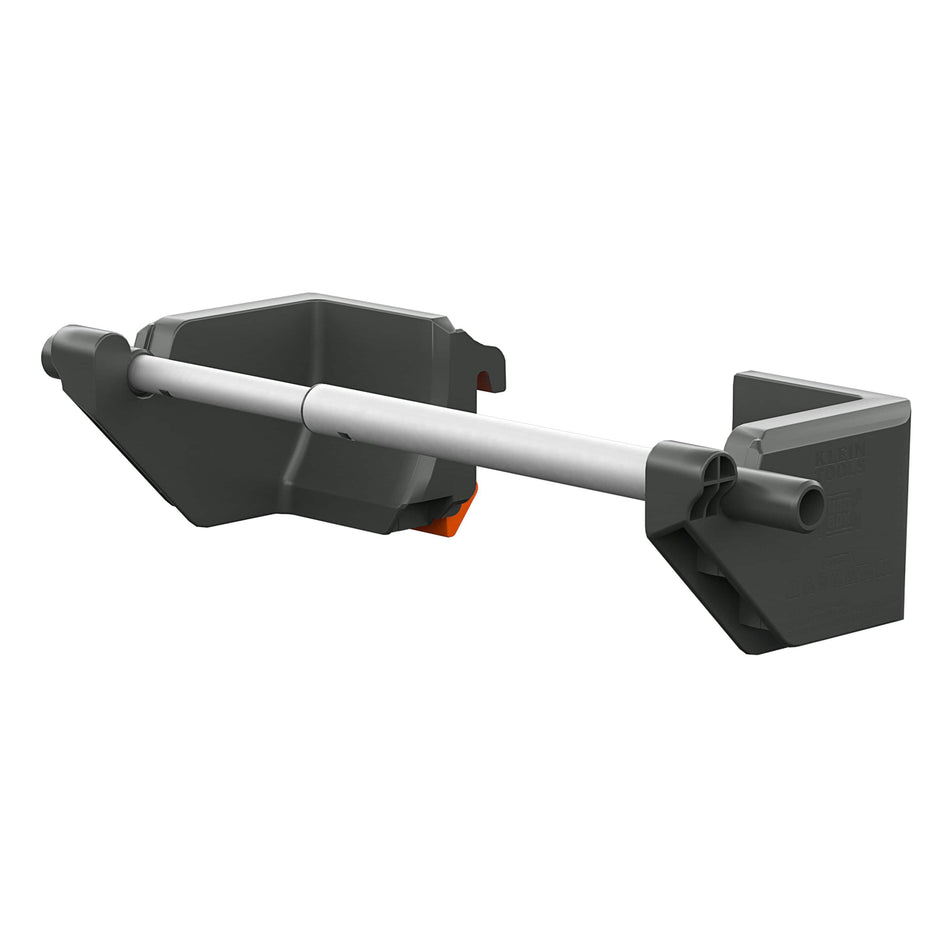 A dark gray plastic wall-mounted pipe hanger or support bracket with a white horizontal pipe segment and a small orange accent tab, shown on a plain white background.