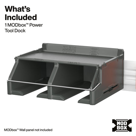 A dark gray plastic tool dock with two compartments, shown on a white background with text detailing what is included and a MODbox logo.