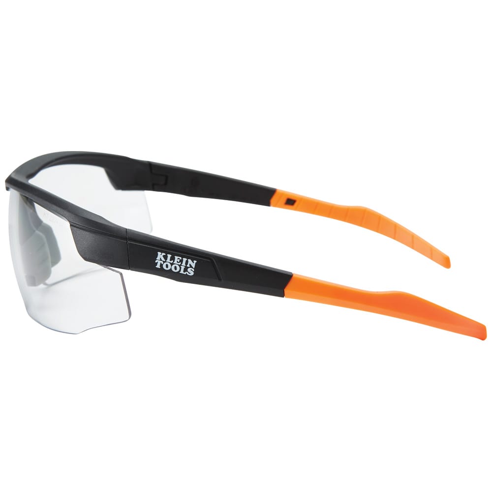 Safety glasses with black and orange frame on a white background