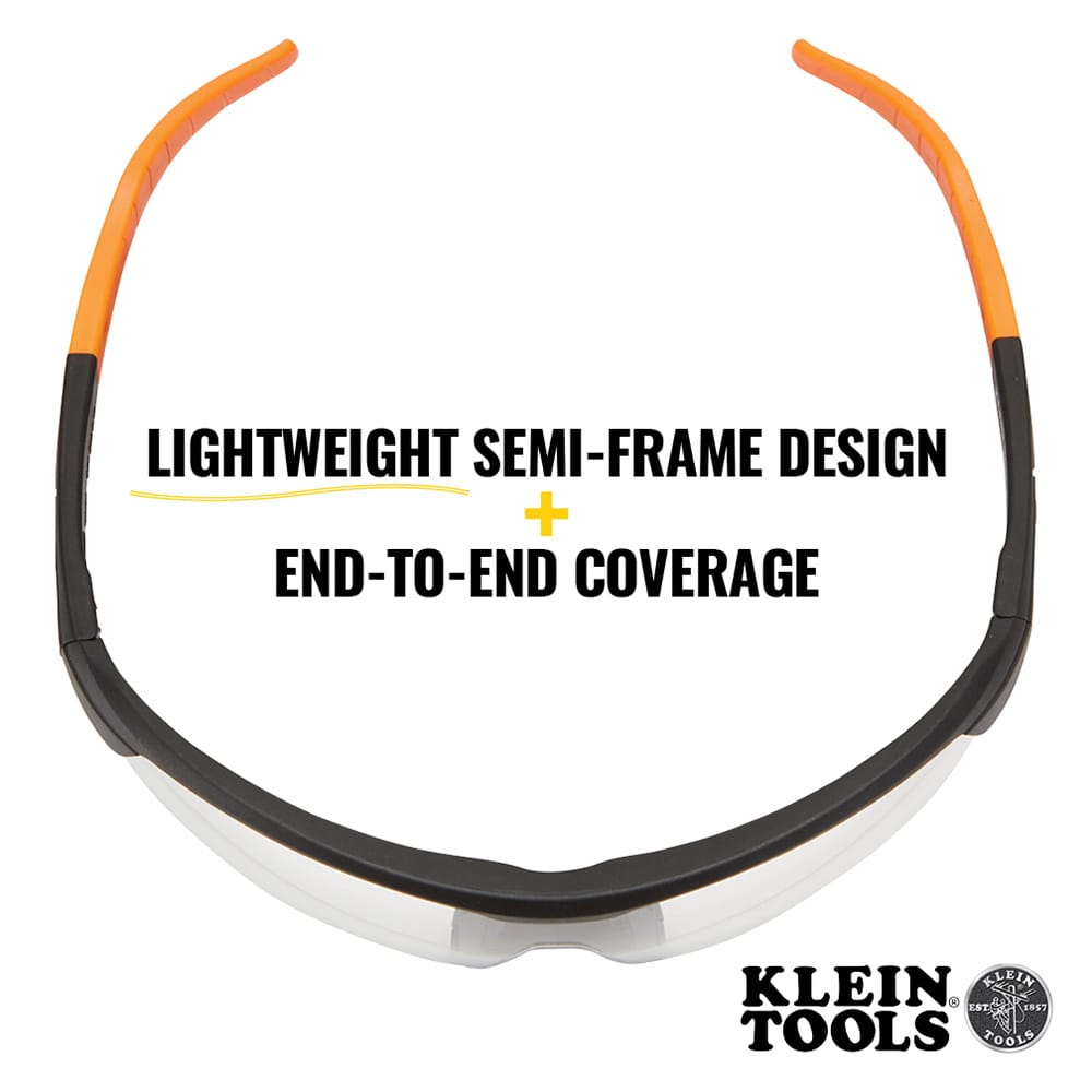 Safety glasses with orange and black frame on a white background, featuring Klein Tools branding.