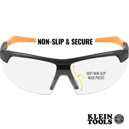 Safety glasses with orange and black frame on a white background, featuring Klein Tools branding.
