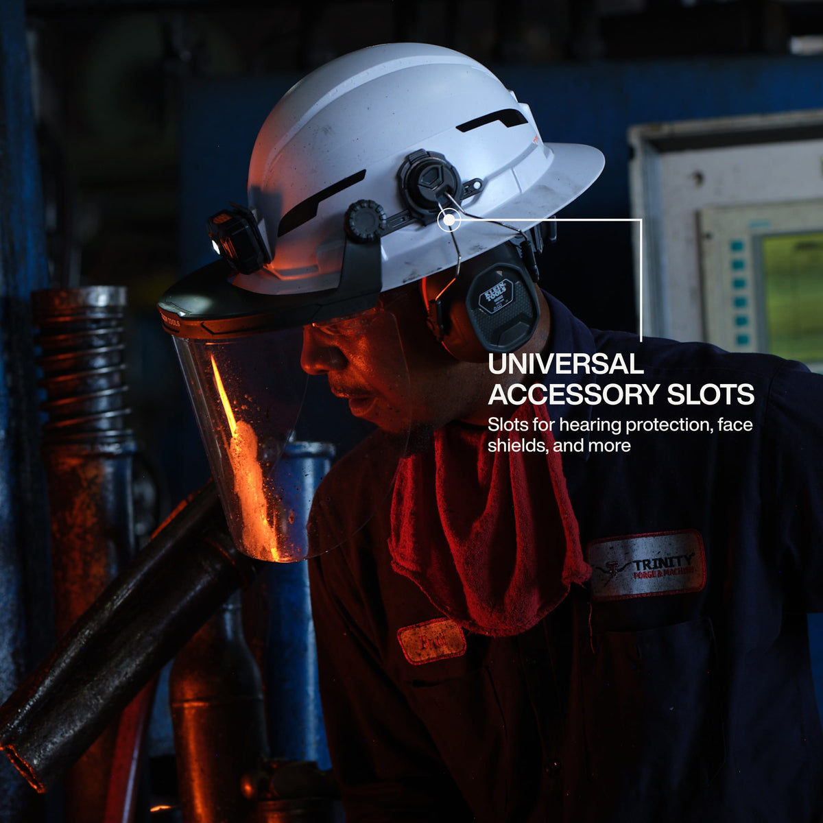 Person wearing a white helmet with universal accessory slots in a workshop setting