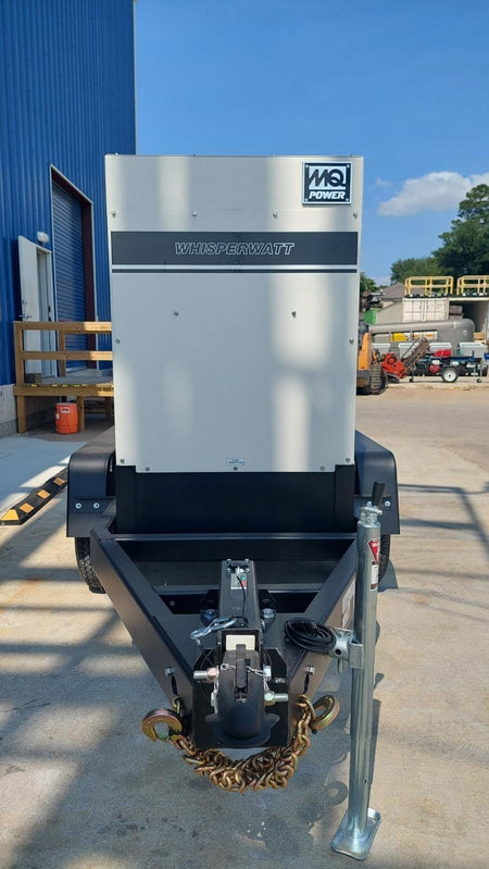 Facing the front of the generator and trailker, With blue skies in the background.
