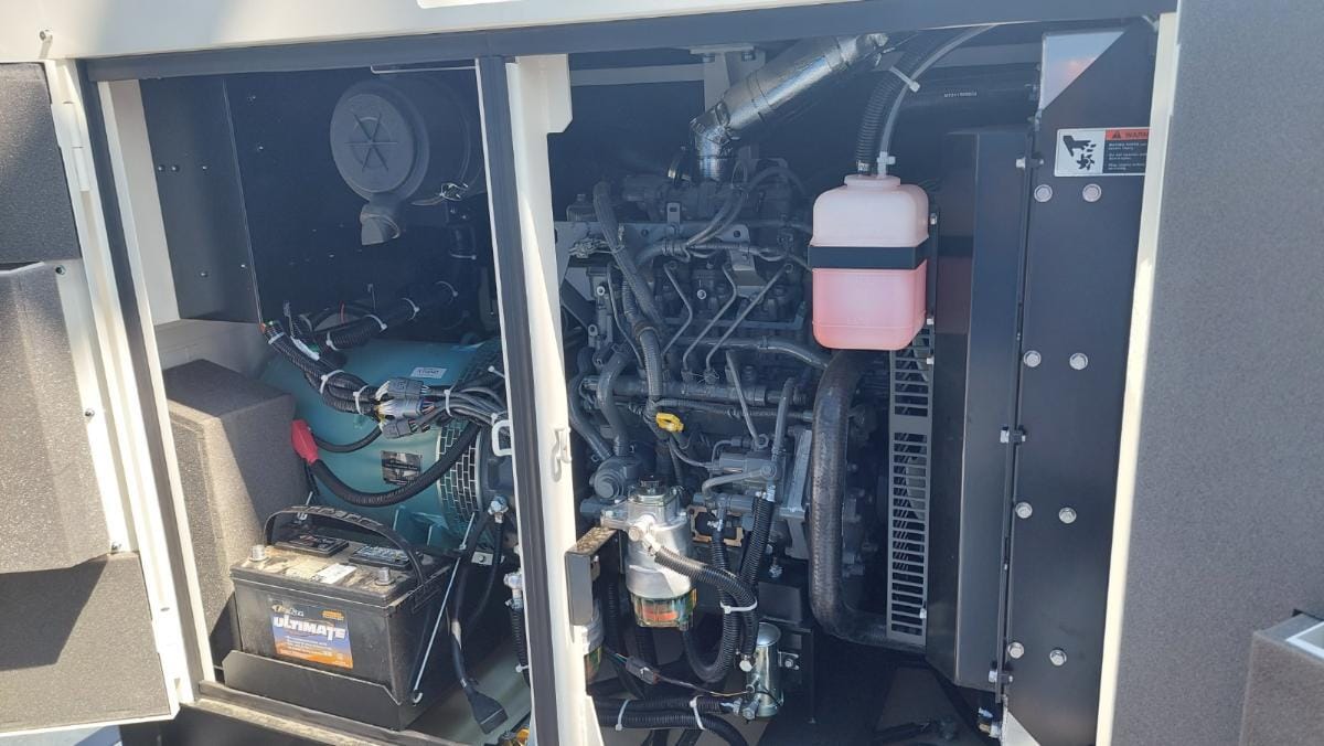 Generator cabinet doos open exposing the engine and generator. 