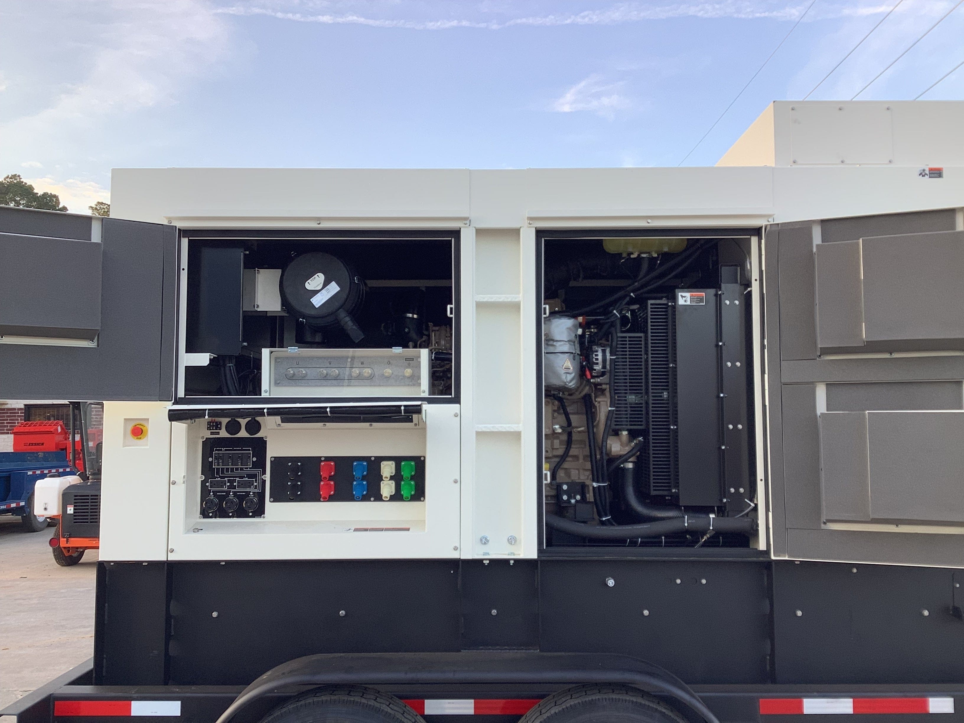Right side of trailer mounted generator, Door open showing the cotroll panel and engine compartmet.