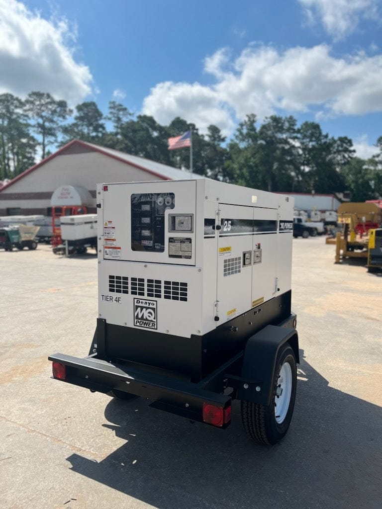 Picture of the generator on the trailer showing the back right corner wiith a american flag flying in the backgroung.