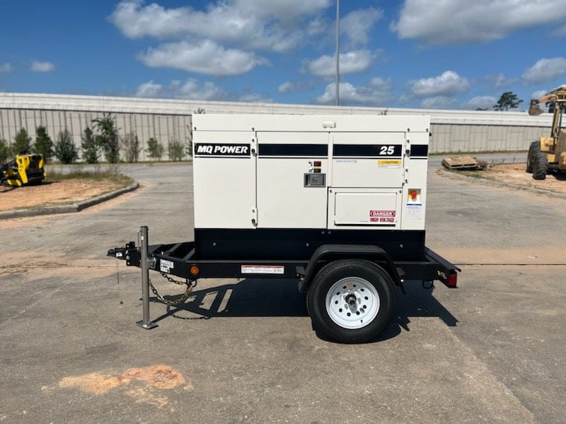  A white and black towable generator labeled "MQ Power 25," indicating it's a 25 kW model mounted on a single-axle trailer with a hitch for towing. It features a sound-dampening enclosure with various access panels and safety labels, suggesting it's designed for portable power generation in different locations.