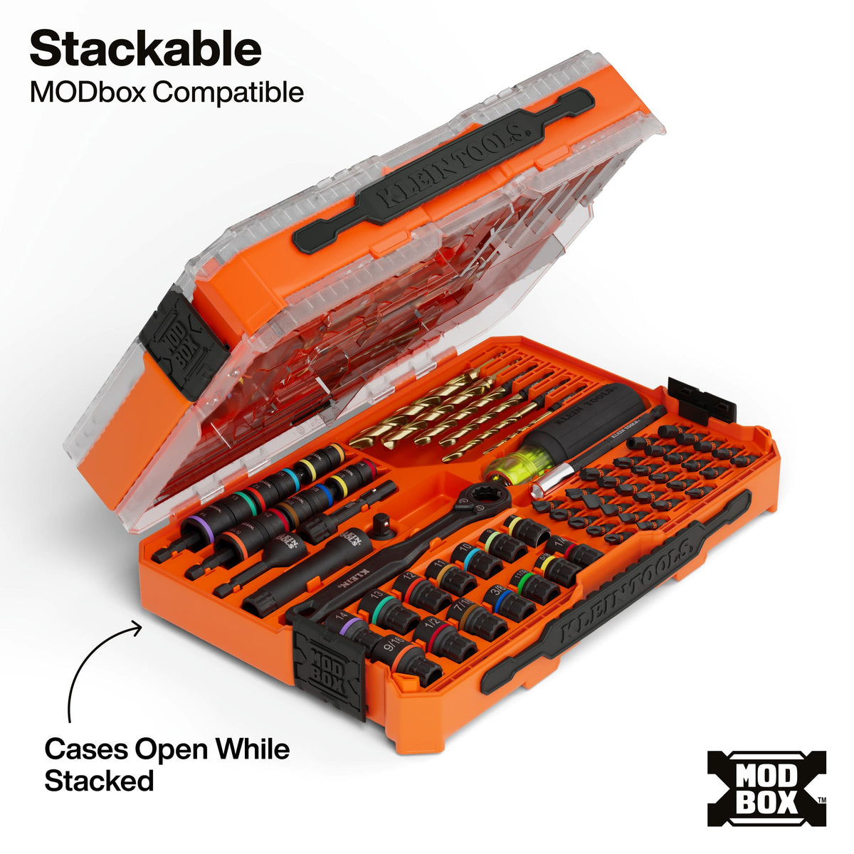 An orange and black modular drill bit set displayed open in a transparent case, with text noting compatibility with MODbox and a callout about stacking. The set includes multiple drill bits, bits holders, and a small level tool on a white background.