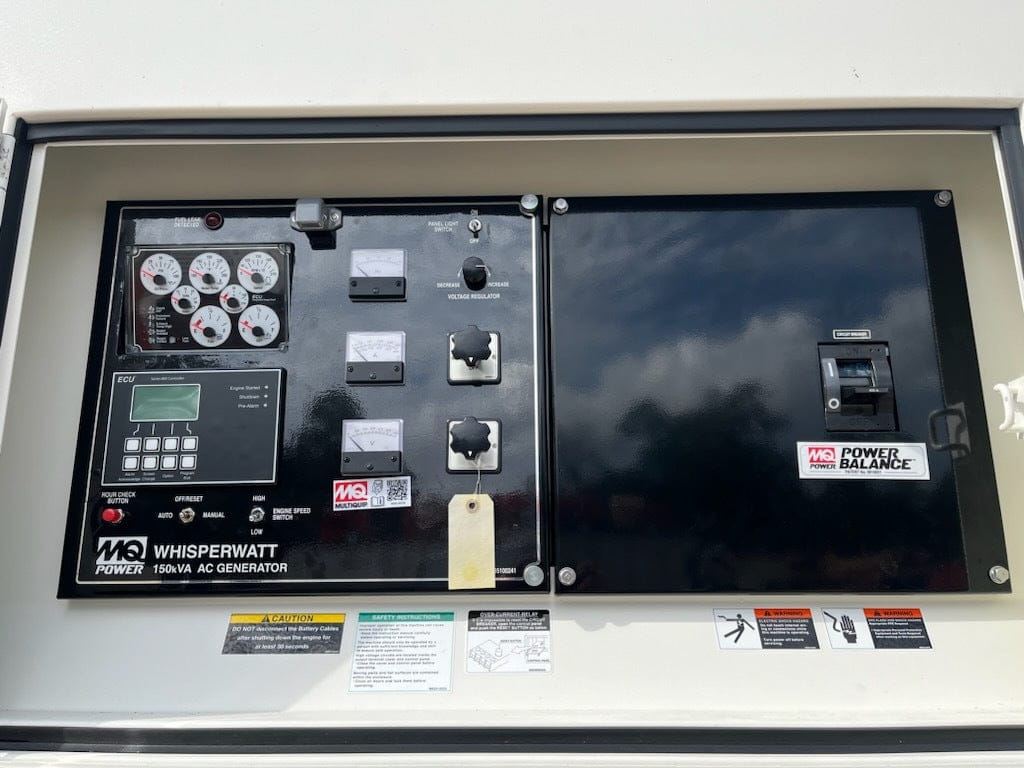  A close-up view of the control panel of an MQ Power 150 kVA AC generator, labeled "Whisperwatt." The panel features various gauges, buttons, switches, and indicator lights, along with safety instructions and warnings.