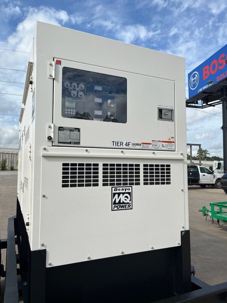 Rear of trailer and generator, control panel visible through the inspection window.