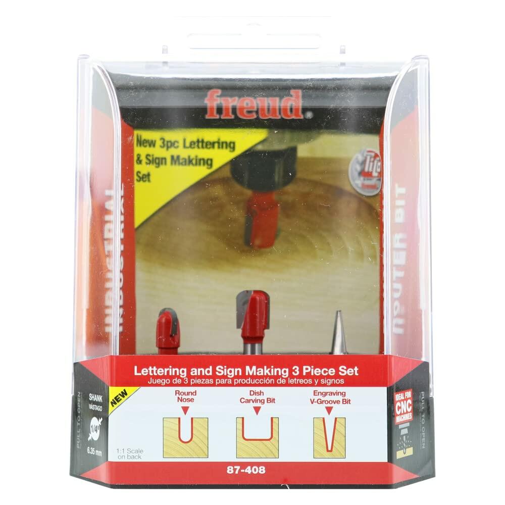 Retail packaging for the Freud 3-piece Lettering and Sign Making Router Bit Set, illustrating the three bit profiles: Round Nose, Dish Carving Bit, and Engraving V-Groove Bit.