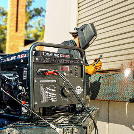  Tomahawk Power 2000 Watt Generator with a 210 Amp Stick and TIG Welder in action! It looks like someone is using the welding function, wearing a welding helmet and gloves. The generator/welder is sitting on what appears to be the back of a truck or trailer. It's great to see the machine we just discussed being used for a task, perhaps even somewhere around Tomball! What are your thoughts on seeing it in this context?
