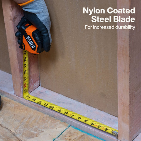 A close-up of a hand wearing a gray and black work glove holding an orange and black tape measure against a wooden frame, with a yellow tape measure also laid along the base. Text on the image reads 'Nylon Coated Steel Blade For increased durability.