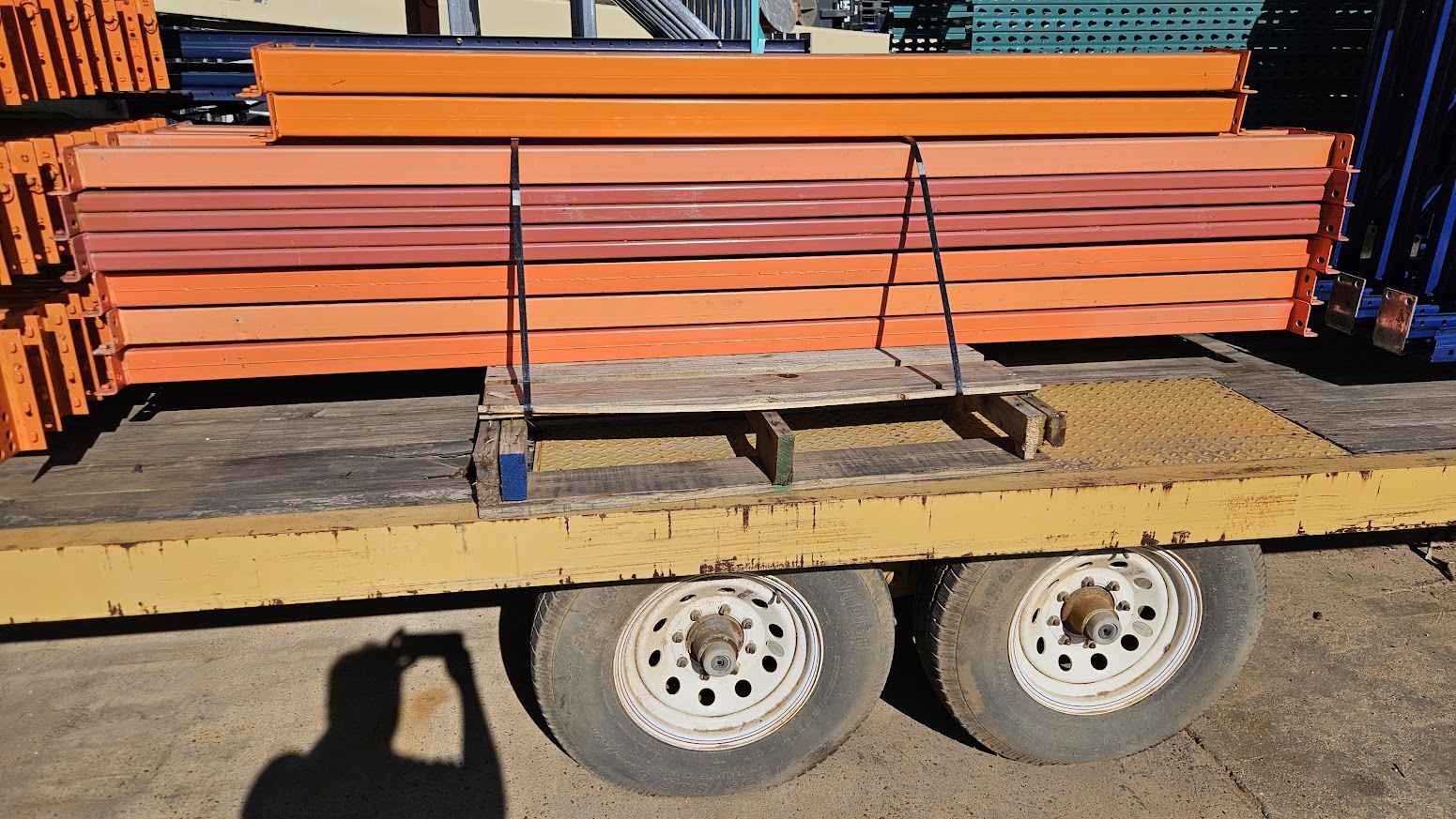 A bundle of 96-inch industrial teardrop pallet rack step beams secured on a transport trailer, highlighting the heavy-duty steel construction and 4-inch face height for industrial warehouse support systems.