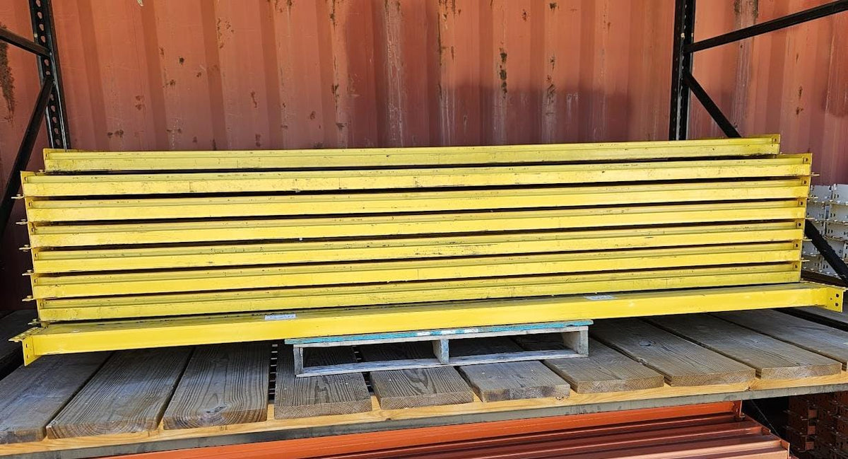 A stack of industrial 9-foot teardrop pallet rack step beams in used condition featuring a durable yellow finish and a 5-inch face height for heavy-duty warehouse storage racking.