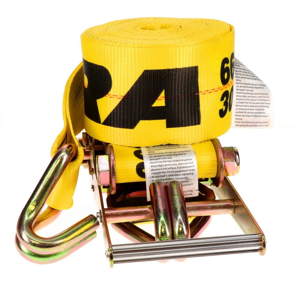 Close-up of the rolled yellow webbing and the heavy-duty ratchet assembly, including the chromate-coated J-hook and safety tags with specifications.