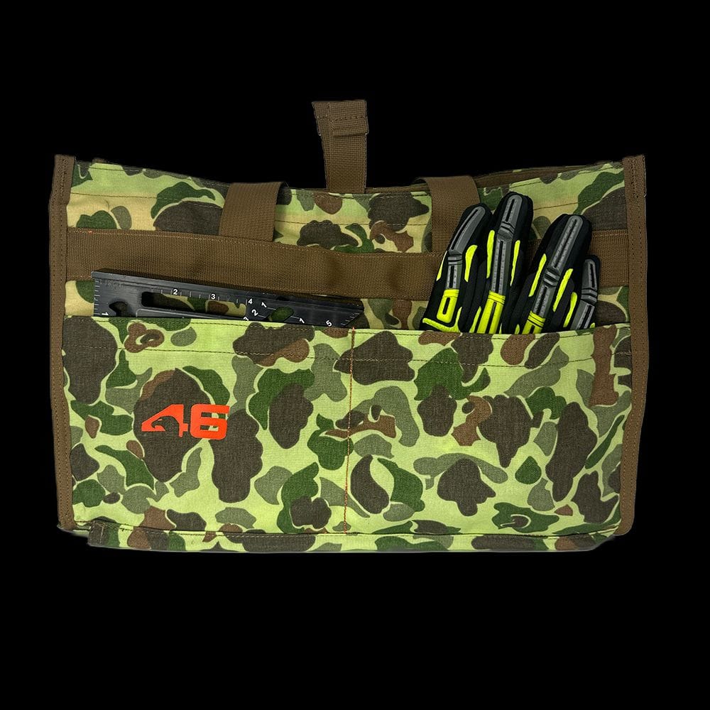 Atlas 46 Quick Tool Bag exterior pockets holding a rafter square and work gloves to demonstrate organized tool access for contractors.