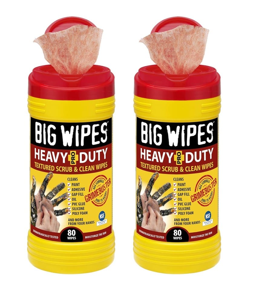 Two bright yellow tubs of Big Wipes Heavy-Duty Textured Scrub & Clean Wipes with red tops, showing wipes dispensing from each, and a graphic of dirty hands being cleaned.