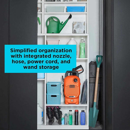 A storage cabinet displays a BLACK+DECKER pressure washer with accessories neatly organized, including hose, wand, power cord, and nozzles. Gardening and cleaning tools are stored alongside.
