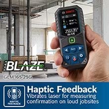 The Bosch BLAZE laser measure held in a hand on a construction site, with a callout graphic explaining its Haptic Feedback feature, which vibrates the laser for measuring confirmation on loud jobsites.