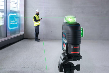 Construction worker using smartphone near Bosch laser level mounted on tripod, with green laser lines and "Simply Connected" display in background