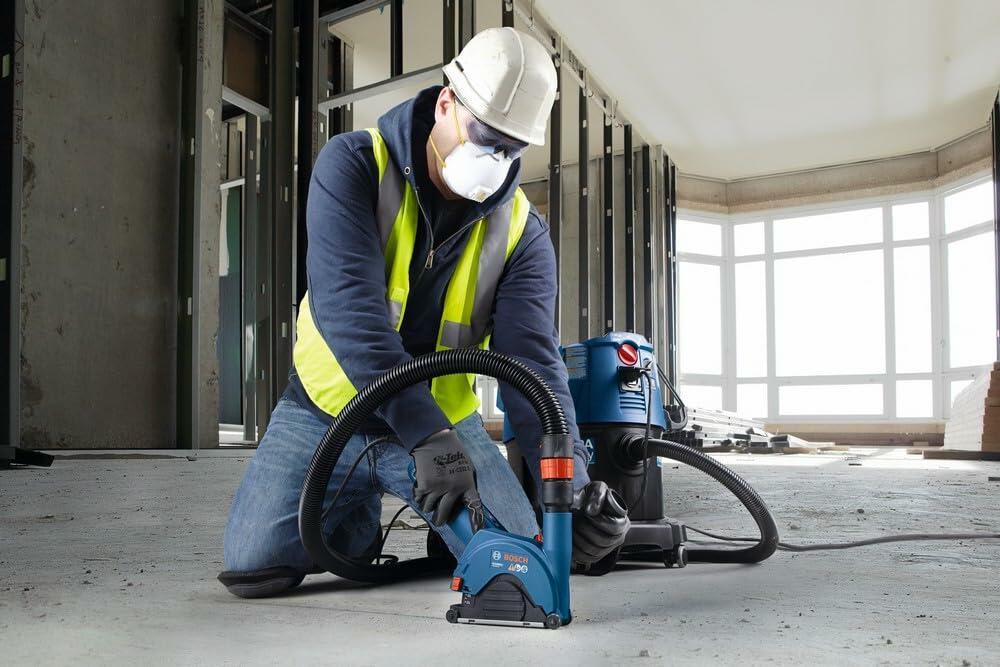 BOSCH DB1041S 10-Inch Segmented Rim Diamond Blade cutting concrete floor by worker with safety gear