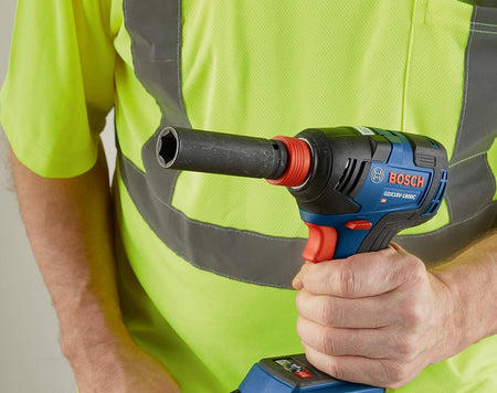 Worker holding a Bosch GDX18V‑1800C reconditioned 18V brushless impact driver with socket attachment, demonstrating ergonomic grip and high‑torque fastening capability in a professional setting.