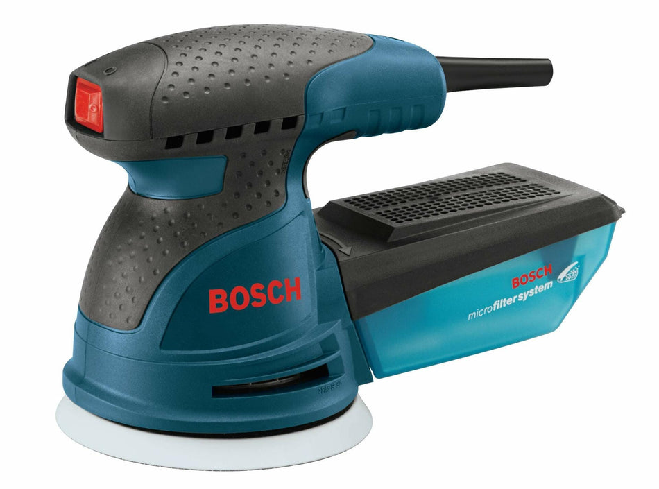 Bosch ROS10 random orbit sander with textured grip, red power button, and visible microfilter dust canister. The sanding pad is shown at the bottom, emphasizing the tool’s swirl-free finish and dust collection capability
