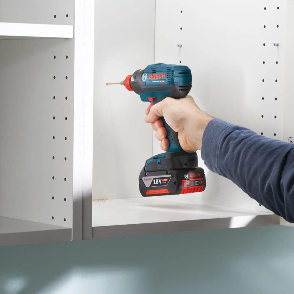User drilling a clean hole into a white wood cabinet using the BOSCH TI9IM titanium drill bit and an 18V impact driver, demonstrating the tool's versatility for both woodworking and interior installation projects.