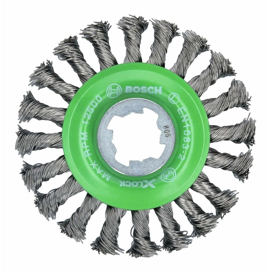 A circular wire brush wheel is shown head-on, featuring a bright green hub at its center. Twisted tufts of silver metallic wires radiate outwards from the hub like spokes, and the hub is marked with the Bosch logo and a maximum RPM rating.