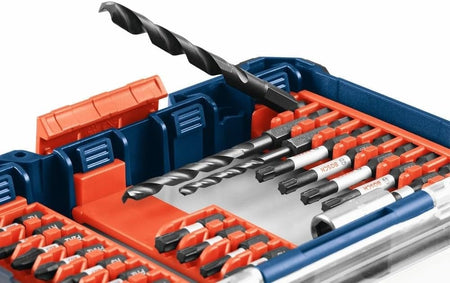 Open Bosch bit set case with red hinged holders displaying screwdriver bits and lower compartments containing drill bits, socket adapter, and spade bits