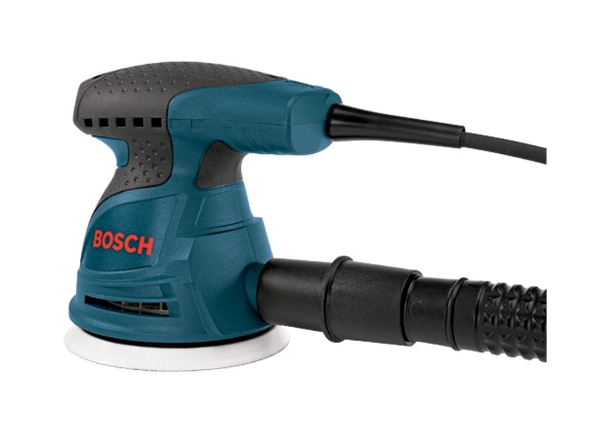 Bosch electric random orbital sander with dust hose attached, round sanding pad, and textured grip, used for surface finishing in woodworking