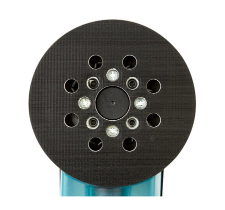 Bottom view of circular sanding pad with dust extraction holes attached to Bosch electric sander, showing textured grip and blue tool body.