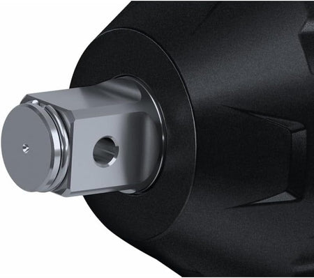 Close-up of a metallic fitting inserted into a black cylindrical housing, showing detailed machining and design for industrial fluid systems