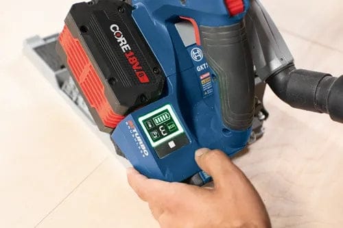 Close-up of Bosch track saw with CORE18V battery and digital display showing battery level and Bluetooth connectivity indicators.