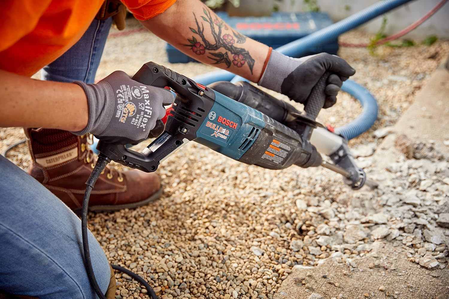 A close-up action shot of the tool chipping into concrete ground, accompanied by text stating 2.0 ft-lbs Hard-Hitting Impact.