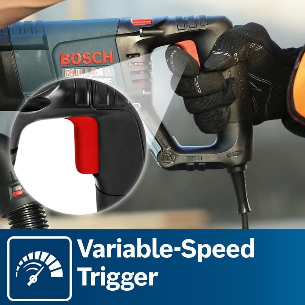 A close-up of a gloved hand pressing the variable-speed trigger on the D-handle, highlighting the ergonomic grip and control.