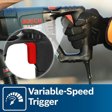 A close-up of a gloved hand pressing the variable-speed trigger on the D-handle, highlighting the ergonomic grip and control.